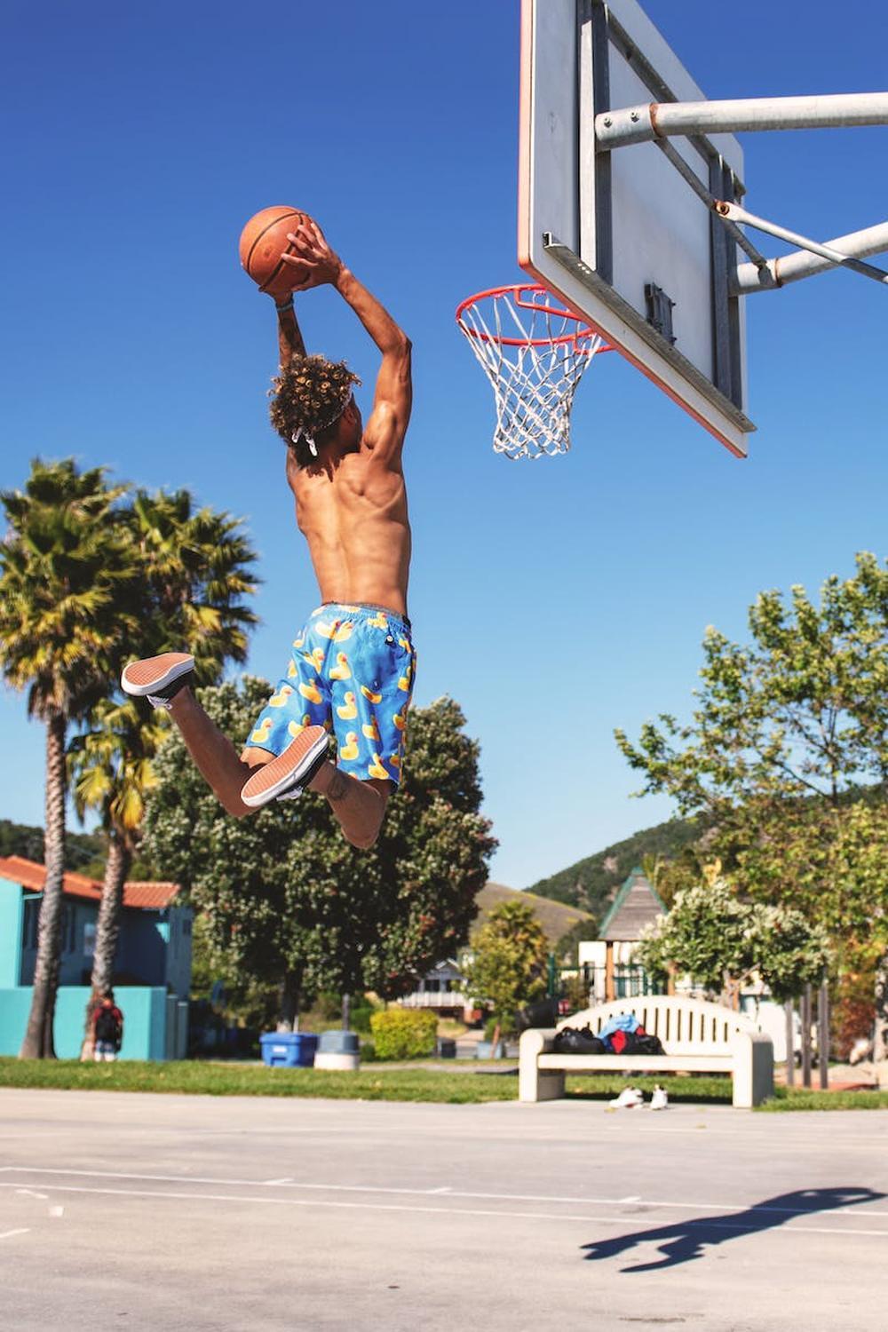 man_wearing_blue_and_yellow_shorts_playing_basketb
